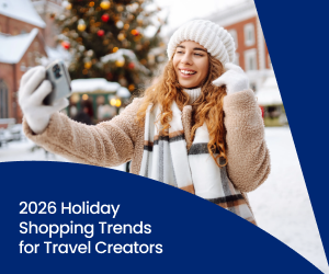 A travel creator poses in front of a Christmas market while wearing a wool knit cap.